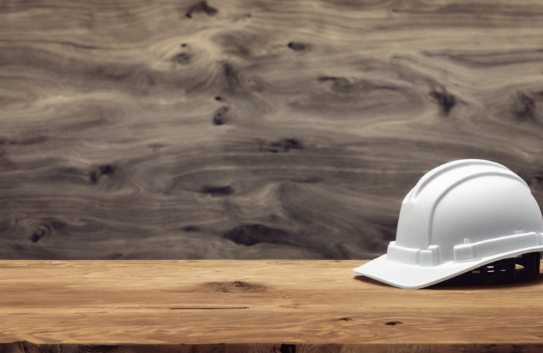 A hardhat sits on a wooden table. Defending Market Share in the Aggregate Industry